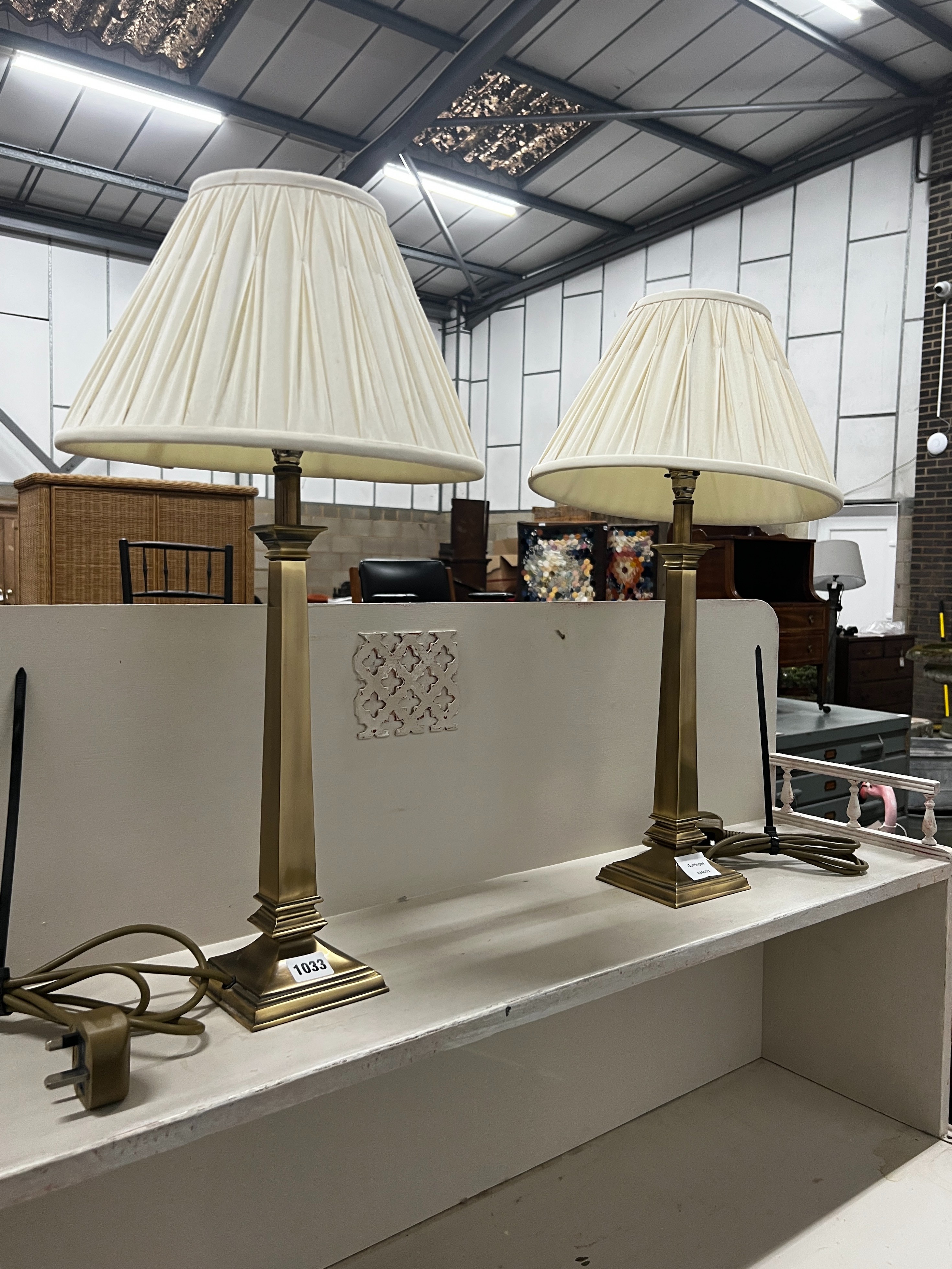 A pair of contemporary brass effect table lamps and shades, height including shades, 58cm